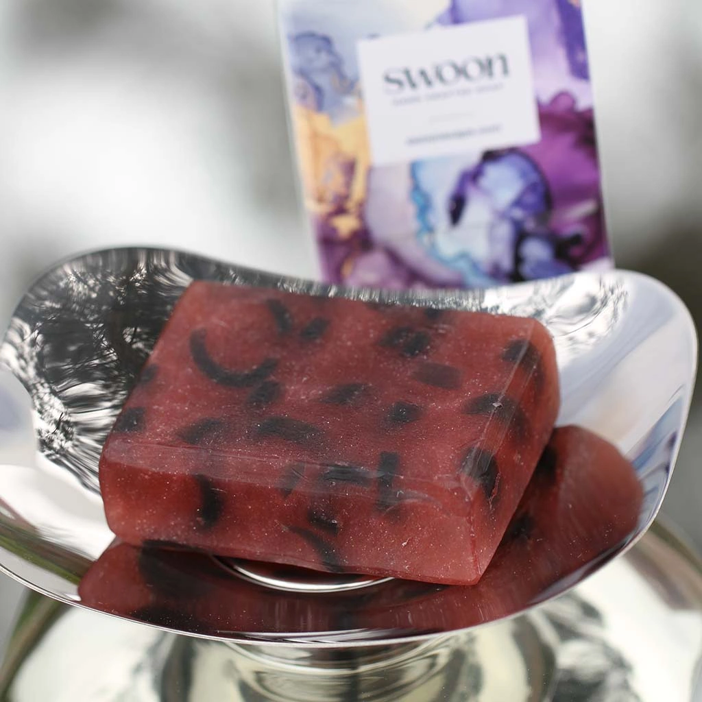Translucent sparkling deep red oblong soap with black accents through it. Minimum weight 95g