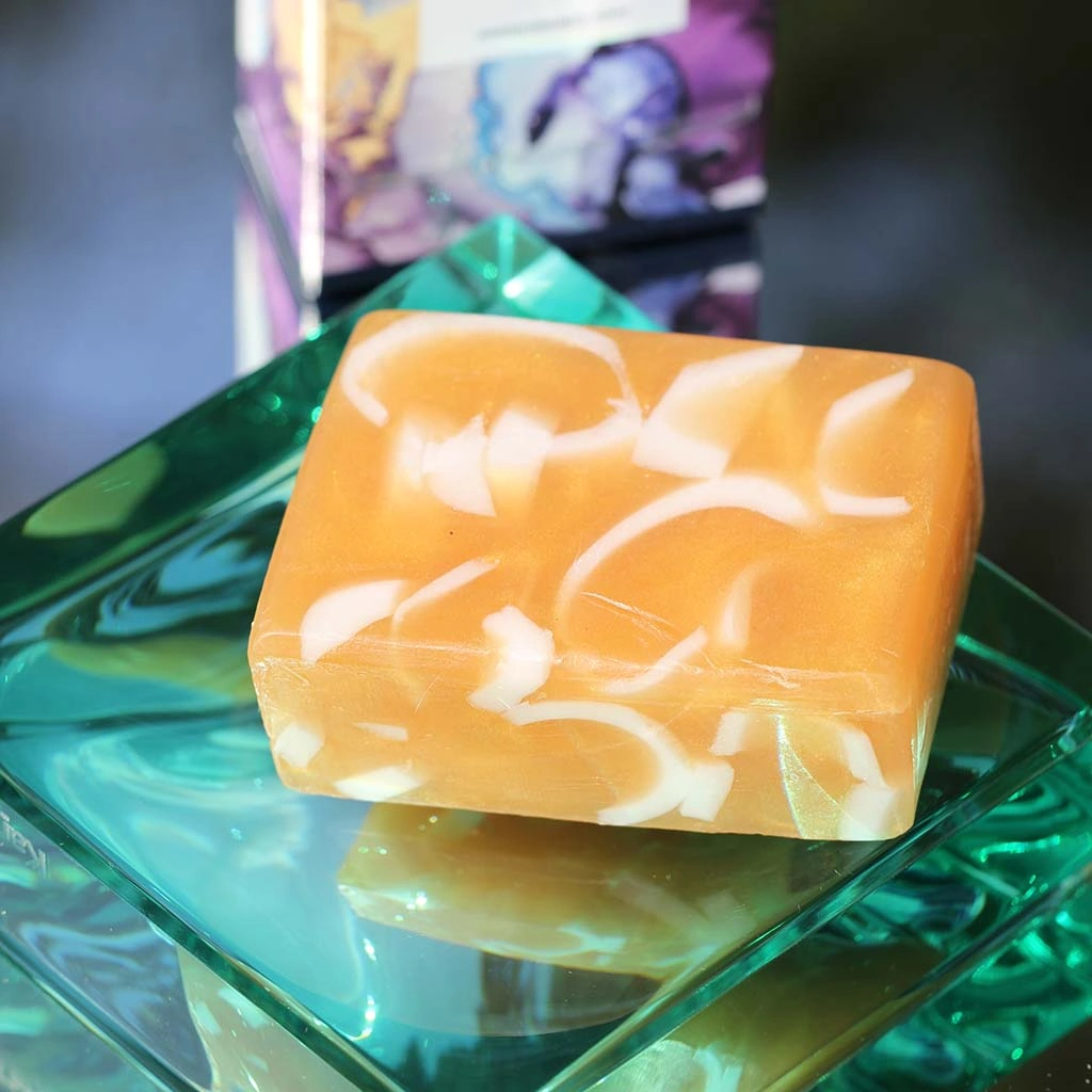 Sparkling gold translucent oblong soap with white swirls throughout. Minimum weight 95g