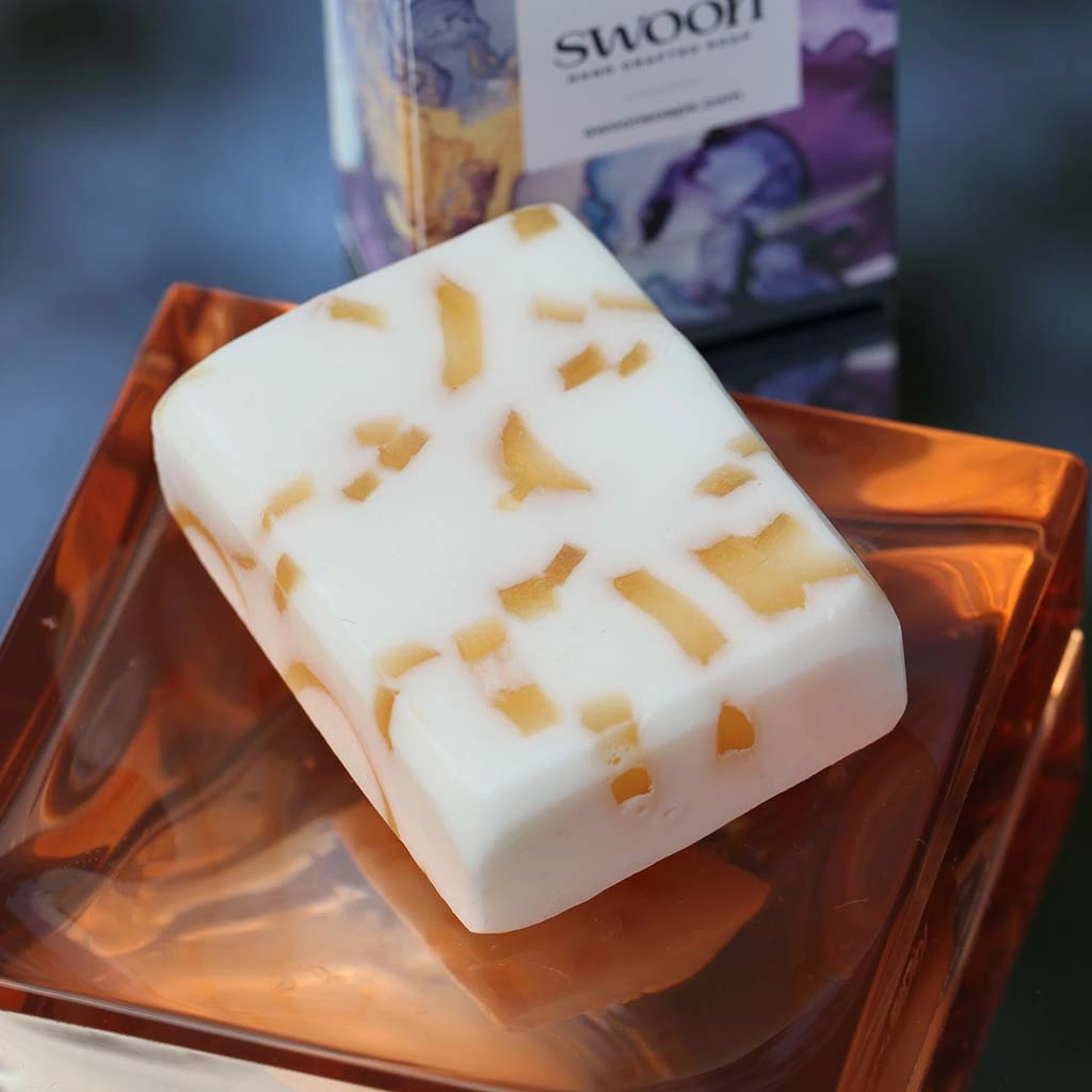 Daisy Swoon Soap. White oblong soap with gold highlights and fresh fragrance. Minimum weight 95g